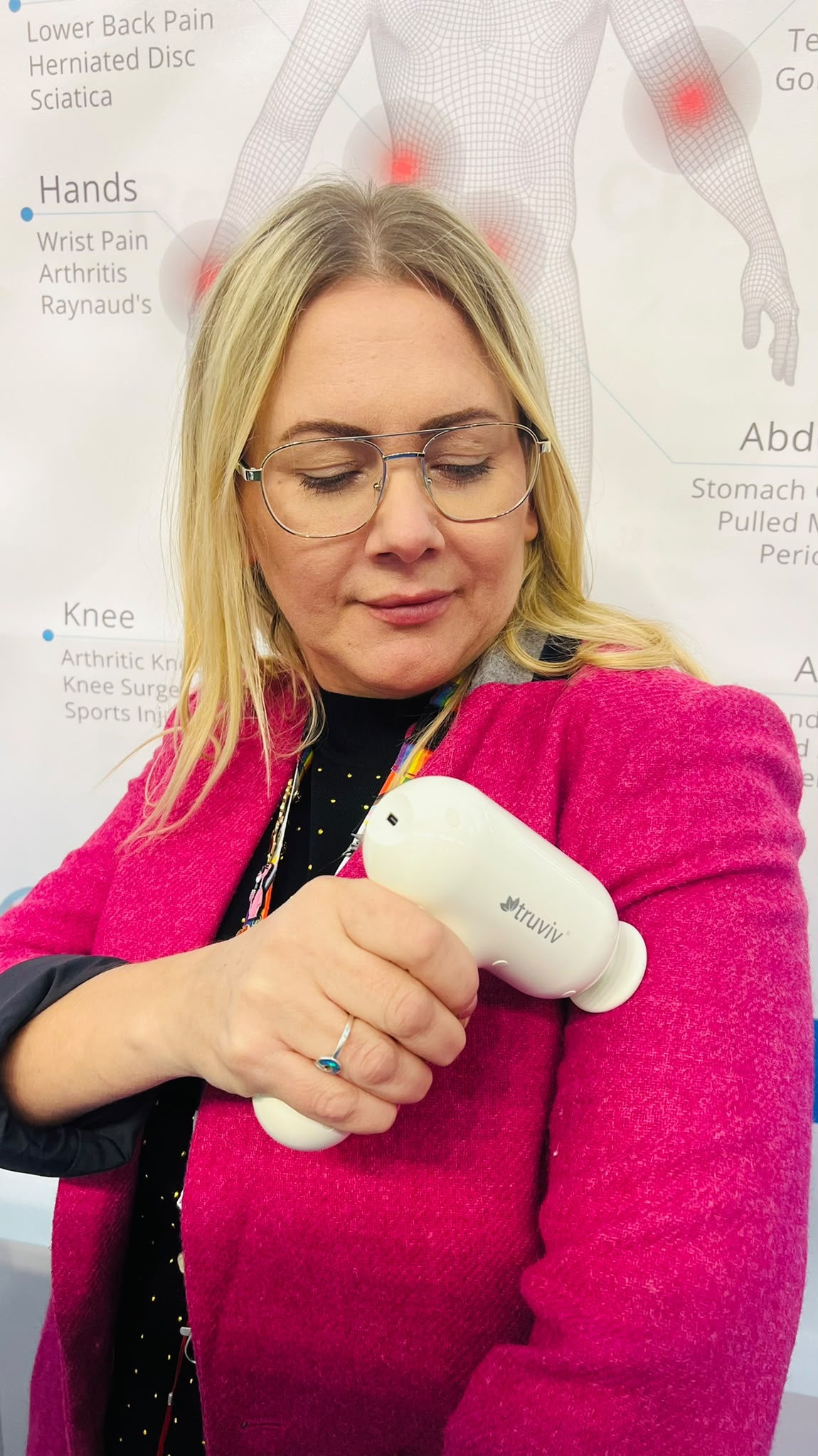 Truviv specialist demonstrating recovery massager at Westfield London